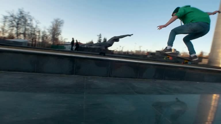 Skateboarder failed tricks on the ramp outdoors in sunset λμμ ...