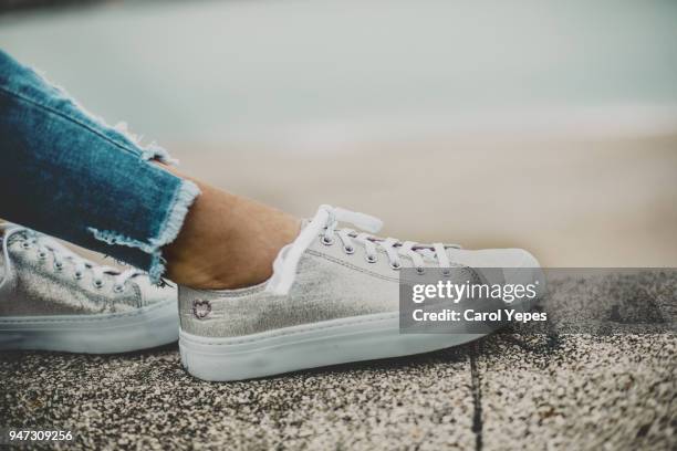 female feet in jeans and sports shoes - teen girls toes stock pictures, royalty-free photos & images