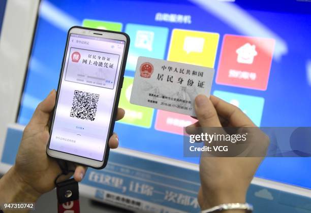 Woman uses her 'electronic ID card' in the mobile payment app Alipay to verify herself as she checks her house accumulation fund and social security...