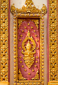 Ancient golden carving wooden window of Loas temple. Pakse Loas.
