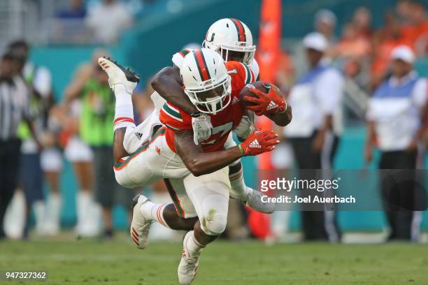 Brian Hightower catches the ball while being defended by DJ Ivey of the Miami Hurricanes during the spring game on April 14, 2018 at Hard Rock...