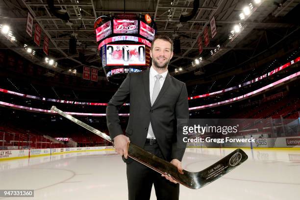 Cam Ward of the Carolina Hurricanes receives a gold stick commemorating his 300th NHL win prior to an NHL game against the Tampa Bay Lightning on...