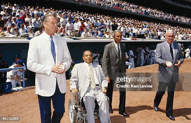 Don Drysdale, Roy Campanella, Sandy Koufax and Duke Snider are shown on the field before a Los Angeles Dodgers game in the 1990 season at Dodger...
