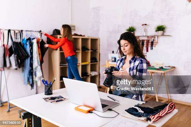fashion designer with camera and laptop in studio - textile for delivery stock pictures, royalty-free photos & images