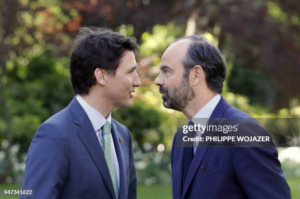 French Prime Minister Edouard Philippe and Canadian Prime Minister Justin Trudeau speak prior to a meeting at the Hotel de Matignon, on April 17,...