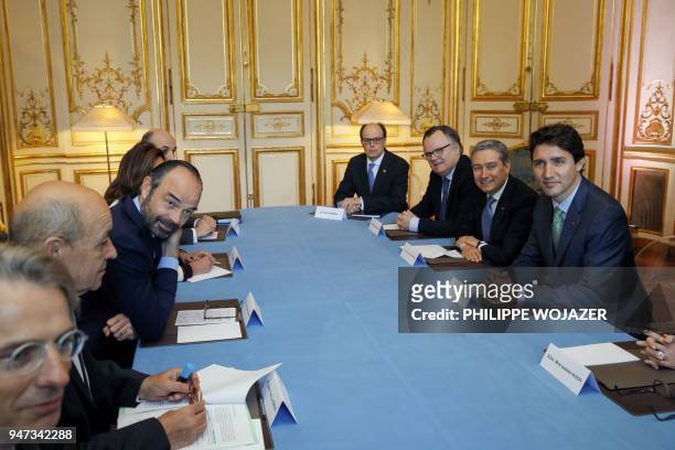 French Prime Minister Edouard Philippe and Canadian Prime Minister Justin Trudeau attend a meeting at the Hotel Matignon in Paris, on April 17, 2018....
