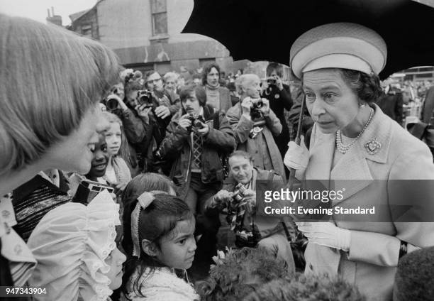 Queen Elizabeth II talking to children in Deptford, during a walkabout to commemorate her Silver Jubilee, London, UK, 9th June 1977.