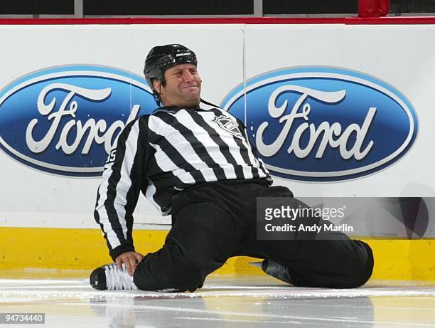 Linesman Jonny Murray stretches just prior to the start of the third period during the game between the Montreal Canadiens and the New Jersey Devils...