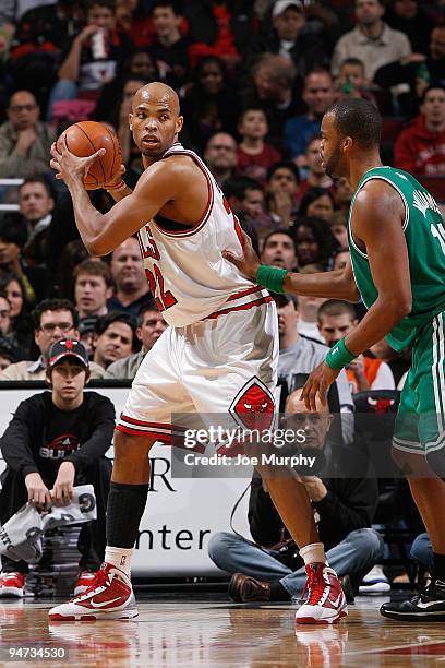 Taj Gibson of the Chicago Bulls handles the ball against Shelden Williams of the Boston Celtics during the game on December 12, 2009 at the United...