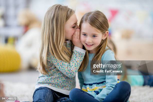 telling secrets - whispering stock pictures, royalty-free photos & images