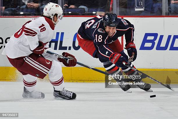 Umberger of the Columbus Blue Jackets reaches to try and take control of the puck away from Sami Lepisto of the Phoenix Coyotes during the first...