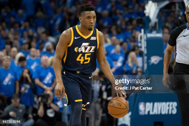 Donovan Mitchell of the Utah Jazz b brings the ball down court against the Oklahoma City Thunder during the first half of Game One of the Western...