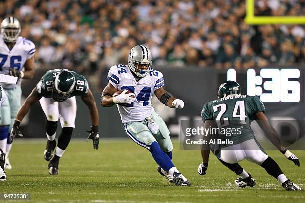 Marion Barber of the Dallas Cowboys runs the ball against Sheldon Brown and Trent Cole of the Philadelphia Eagles at Lincoln Financial Field on...