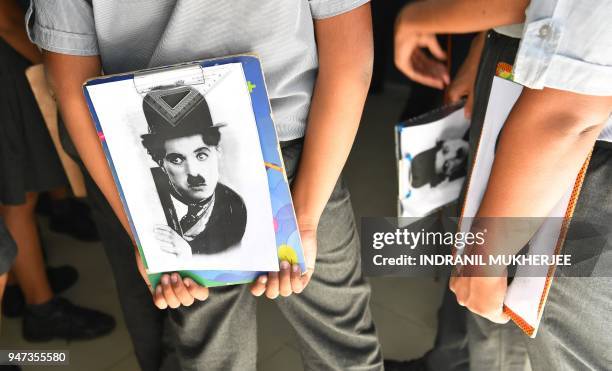 In this photograph taken on April 16 students stand together after a drawing competition organised by the Charlie Circle fan club on the occasion of...