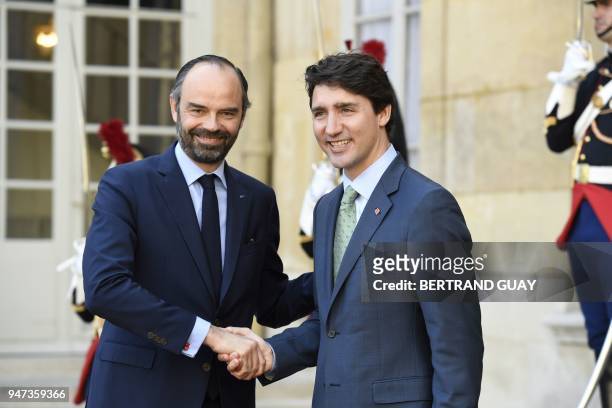 French Prime Minister Edouard Philippe accompanies Canadian Prime Minister Justin Trudeau leaving the Hotel Matignon in Paris, on April 17 after...