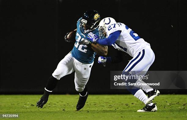 Maurice Jones-Drew of the Jacksonville Jaguars runs the ball against Jacob Lacey of the Indianapolis Colts at Jacksonville Municipal Stadium on...