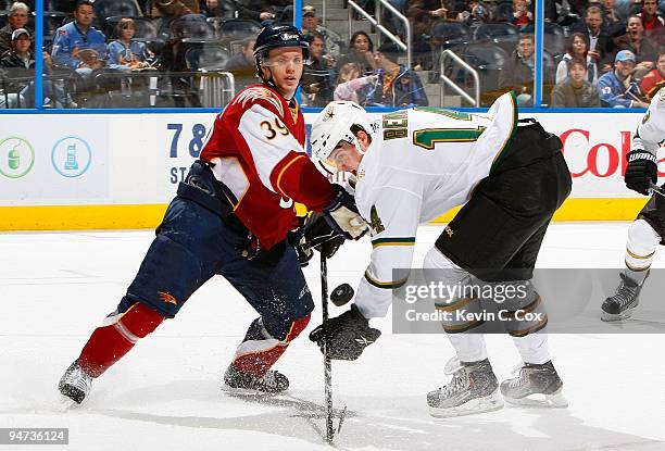 Jamie Benn of the Dallas Stars battles for the puck against Tobias Enstrom of the Atlanta Thrashers into the boards at Philips Arena on December 17,...