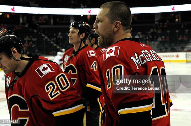 Brian McGrattan, Curtis Glencross and Jay Bouwmeester of the Calgary Flames skates during the warmup before the game against the Los Angeles Kings on...