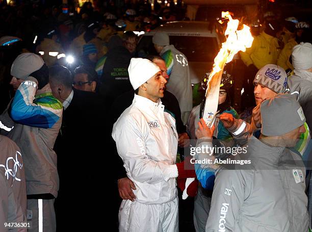 The light is extinguished by an official with Indian film actor Akshay Kumar as protestors close off Yonge St during the Vancouver 2010 Olympic Torch...