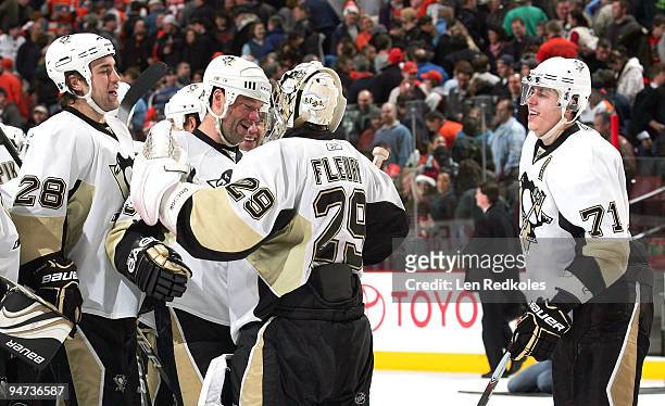 Eric Goddard, Bill Guerin, Marc-Andre Fleury and Evgeni Malkin of the Pittsburgh Penguins celebrate their 3-2 shoot-out win over the Philadelphia...