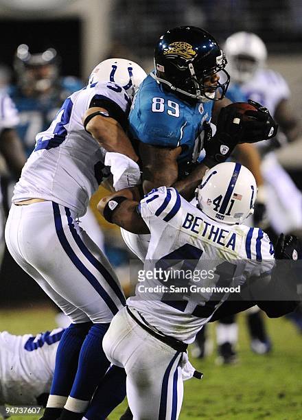 Marcedes Lewis of the Jacksonville Jaguars makes a reception against Tim Jennings and of the Indianapolis Colts at Jacksonville Municipal Stadium on...