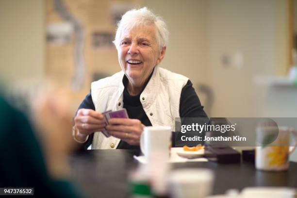 senior woman plays cards. - cards stockfoto's en -beelden