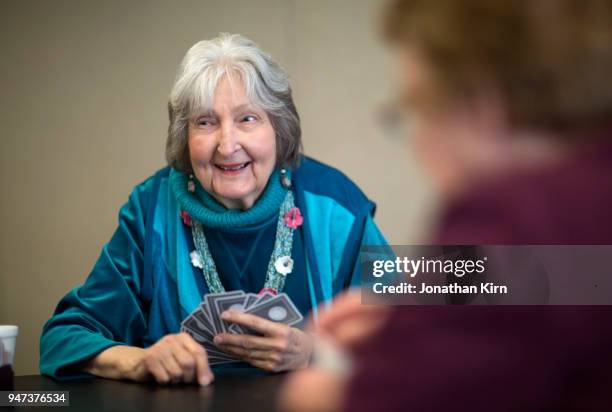 senior woman plays cards. - bridge card game stock pictures, royalty-free photos & images