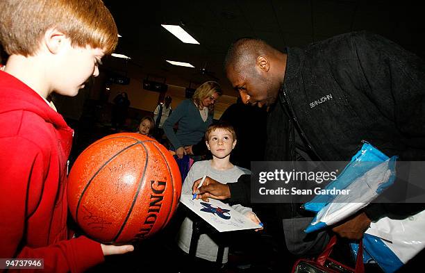 Julian Wright of the New Orleans Hornets signs autographs while attending the 3rd Annual "Peja's Charitabowl" Fundraiser at All-Star Lanes on...