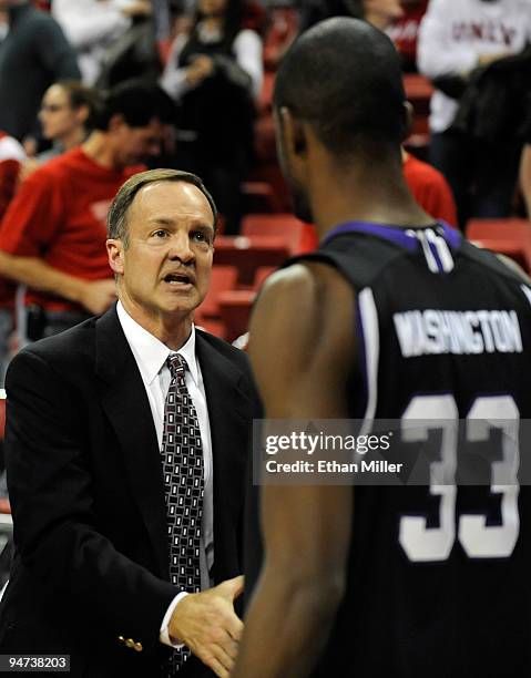 Rebels head coach Lon Kruger shakes hands with Matt Washington of the Weber State Wildcats after the Rebels won their game 72-63 at the Thomas & Mack...