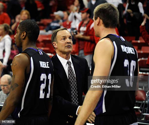 Rebels head coach Lon Kruger shakes hands with Josh Noble and Darin Mahoney of the Weber State Wildcats after the Rebels won their game 72-63 at the...