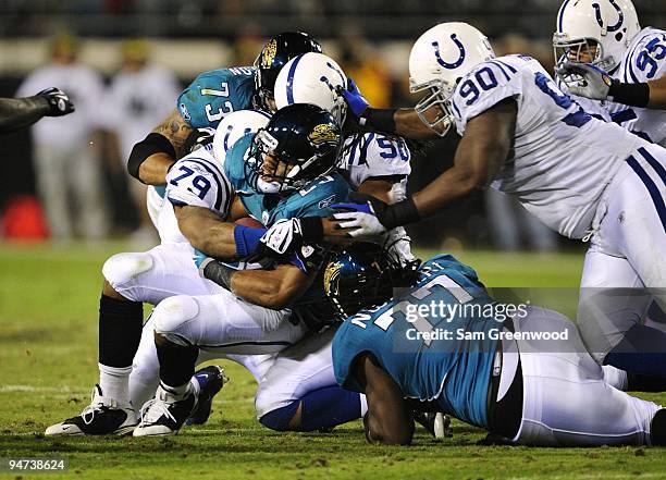 Maurice Jones-Drew of the Jacksonville Jaguars is stopped by the Indianapolis Colts at Jacksonville Municipal Stadium on December 17, 2009 in...