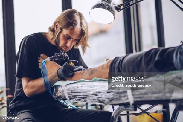 getting a new leg tattoo - tattoo spectacular stock pictures, royalty-free photos & images