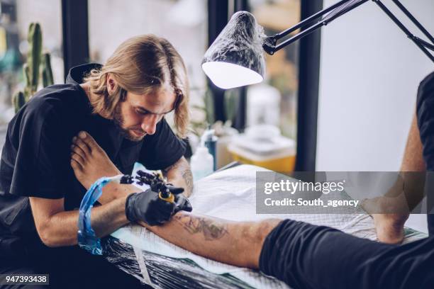 leg tattoo in making - surgical needle stock pictures, royalty-free photos & images