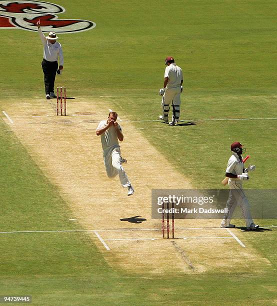 Doug Bollinger of Australia kisses the Coat of Arms on his shirt as he celebrates the wicket of Dwayne Bravo of the West Indies during day three of...