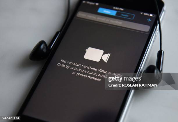 This photo illustration taken on April 17, 2018 shows the FaceTime app for video and audio calls on an Apple iPhone 6s in Singapore. / AFP PHOTO /...