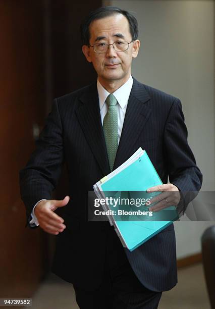 Masaaki Shirakawa, governor of the Bank of Japan, arrives for a news conference at the central bank's headquarters in Tokyo, Japan, on Friday, Dec....