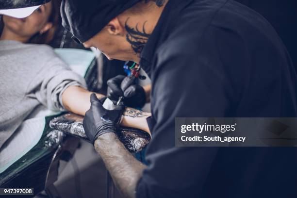 busy guy tattoo artist - surgical suture stock pictures, royalty-free photos & images