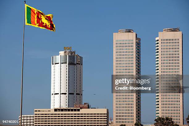 The Sri Lankan flag flies in front of the Bank of Ceylon, left, and the World Trade Towers in Colombo, Sri Lanka, on Thursday, Dec. 17, 2009. Sri...