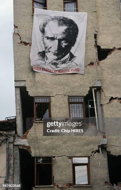 Devastating earthquake struck Golcuk, home to one of Turkey's largest naval bases, here Ataturk poster hanging on a wrecked building facade, August...
