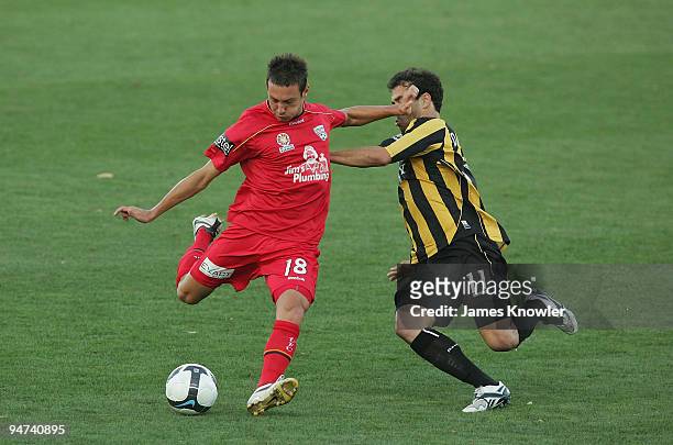 Fabian Barbiero of United is tackled by Daniel Cortes of the Phoenix during the round 20 A-League match between Adelaide United and the Wellington...