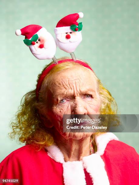 miserable mother in law, dressed as santa claus.  - mother in law stock pictures, royalty-free photos & images