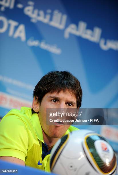 Lionel Messi of FC Barcelona listens to questions from the media during a press conference at the Zayed Sports City stadium on December 18, 2009 in...
