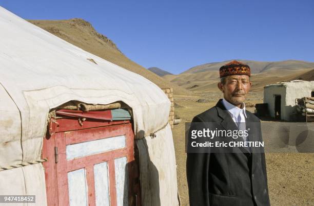 KAZAKH IN FRONT OF HIS YURT, BORIAT HILL, ALTAI RANGE, BAYAN OLGII PROVINCE, MONGOLIA.