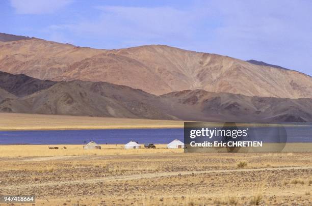 NOMAD CAMP, MONGOL YURTS IN FRONT OF LAKE TOLBO NUUR, ALTAI RANGE, BAYAN OLGII PROVINCE, MONGOLIA.