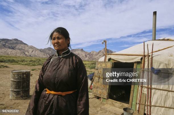 NOMAD WOMAN IN FRONT OF HER YURT, EEJKHAIRKHAN SACRED MOUNTAIN , ALTAI RANGE, GOBI ALTAI PROVINCE, MONGOLIA.
