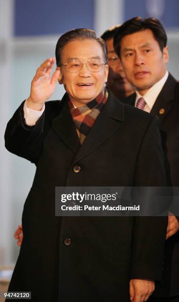 Chinese Premier Wen Jiabao waves to reporters as he arrives for the final day of the UN Climate Change Conference on December 18, 2009 in Copenhagen,...