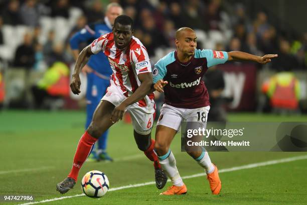 Kurt Zouma of Stoke City battles with Joao Mario of West Ham United during the Premier League match between West Ham United and Stoke City at London...