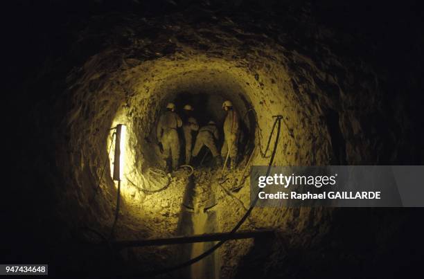 Workers digging into the chalk rock during construction of the Channel Tunnel at Sangatte, January 5, 1990.