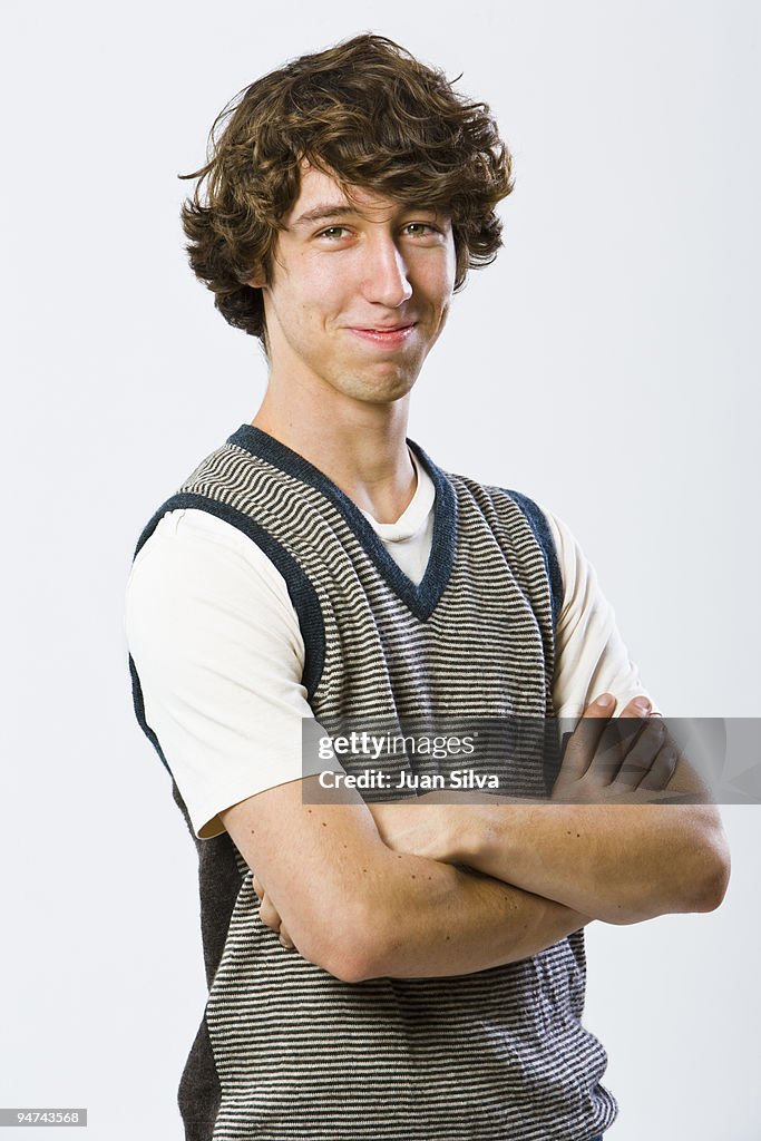 Portrait of teenager standing with arms crossed