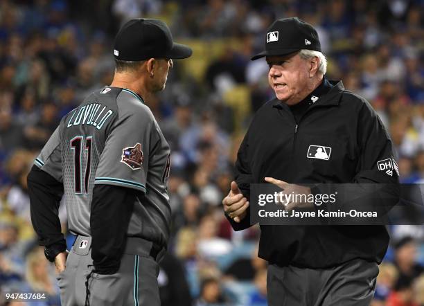 Umpire Brian Gorman explains the ruling on the field to overturn a home run call to manager Torey Lovullo of the Arizona Diamondbacks in the fourth...